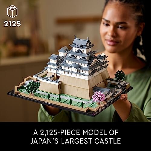 Person holding a 2,125-piece LEGO model of Japan's largest castle.